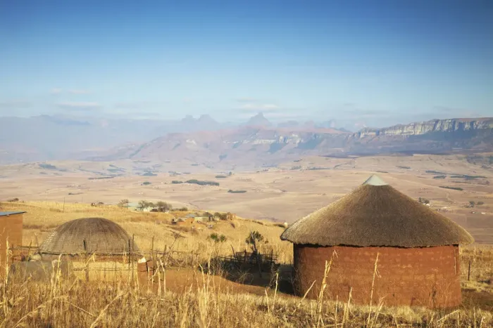 Framed Print : Village huts with Cathedral Peak in background, Ukhahlamba-Drakensberg Park, KwaZulu-Natal Framed Print : Village huts with Cathedral Peak in background, Ukhahlamba-Drakensberg Park, KwaZulu-Natal