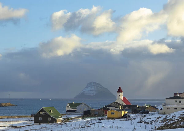 The village of Hvalba covered by snow. In the background the island of Litla Dimun. Suðuroy, Faroe Islands