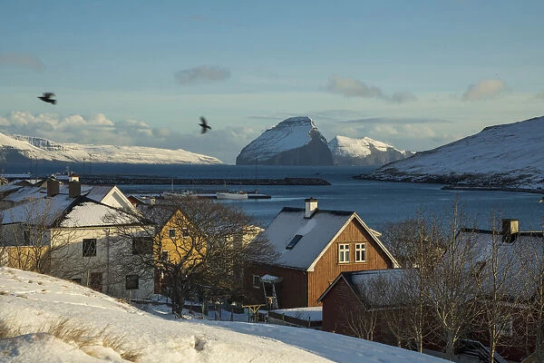 The village of Miðvagur covered by snow. The island of Koltur in the background. Vagar, Faroe Islands