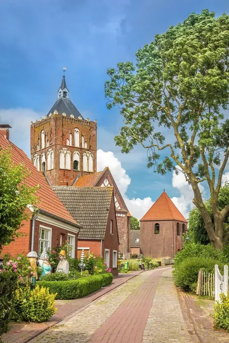 Framed Print : Village street and Kreuzkirche Pilsum, Krummhoern, East Frisia, Lower Saxony, Germany Framed Print : Village street and Kreuzkirche Pilsum, Krummhoern, East Frisia, Lower Saxony, Germany