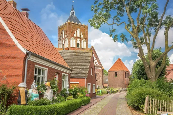 Framed Print : Village street and Kreuzkirche Pilsum, Krummhoern, East Frisia, Lower Saxony, Germany Framed Print : Village street and Kreuzkirche Pilsum, Krummhoern, East Frisia, Lower Saxony, Germany