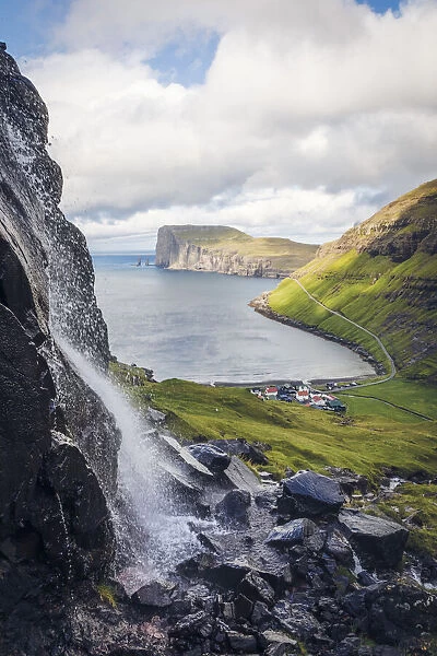 The village of Tjornuvik. In the background Rising and Kellingin sea stacks. Streymoy, Faroe Islands