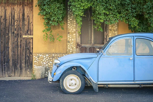 Vintage blue Citroa'n 2cv parked in front of a house in Castellet, Vaucluse