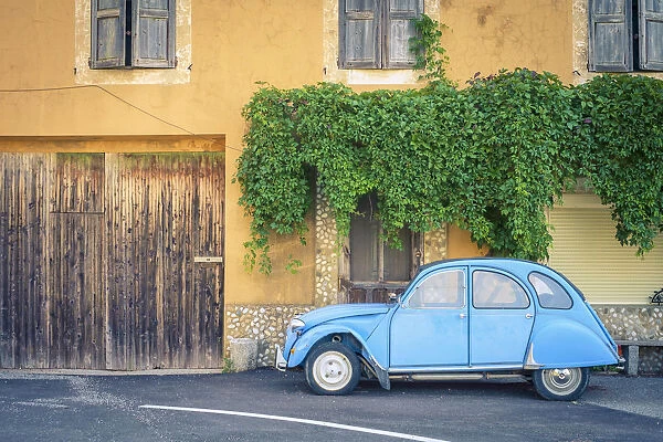 Vintage blue Citroen 2cv parked in front of a house in Castellet, Vaucluse