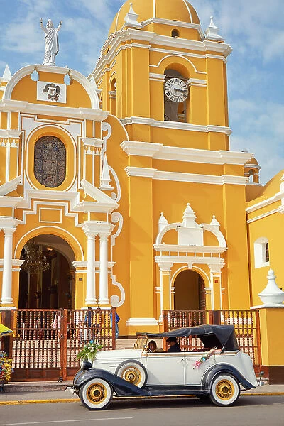 A vintage car in front of the Cathedral Basilica of St. Mary in the 'Plaza de Armas'of Trujillo, La Libertad, Peru