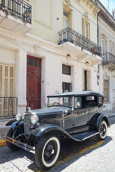 A vintage Ford Model A car in front of a colonial house in San Telmo, Buenos Aires, Argentina