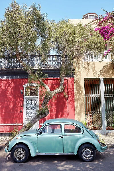 A vintage Volkswagen beetle car in front of a colonial house in Barranco, Lima, Peru. Lima is also known as the 'City of the Kings'and was declared UNESCO World Heritage site in 1988