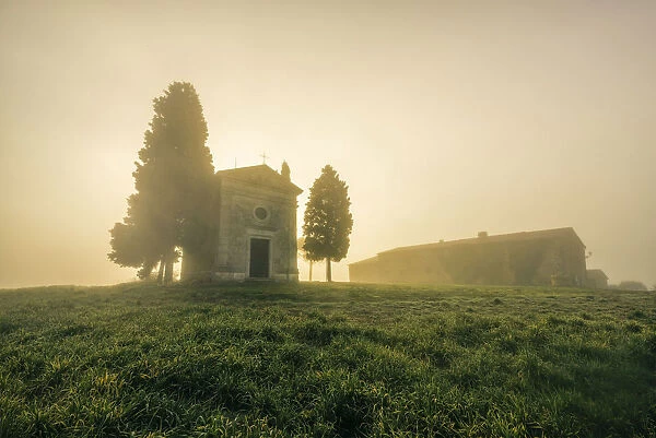 Vitaleta Chapel covered with fog during autumn, Val d Orcia, Tuscany, Italy
