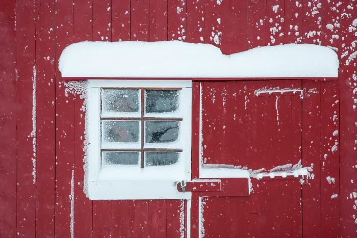 Framed Print : Wall of red timber rorbu (cabin) covered in snow, Bergsbotn, Senja, Norway