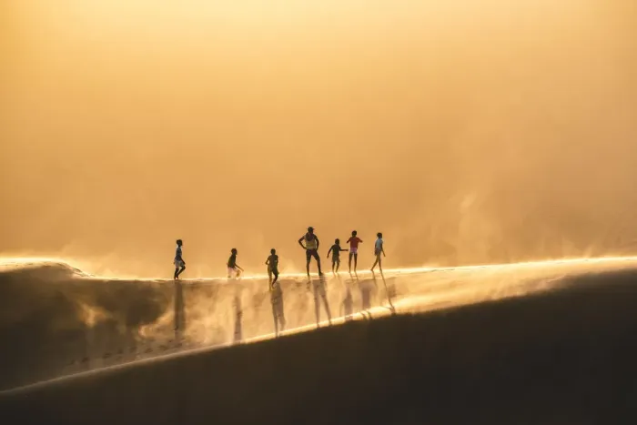 Framed Print : Walvis Bay, Namibia, Africa. People walking on the edge of a sand dune at sunset