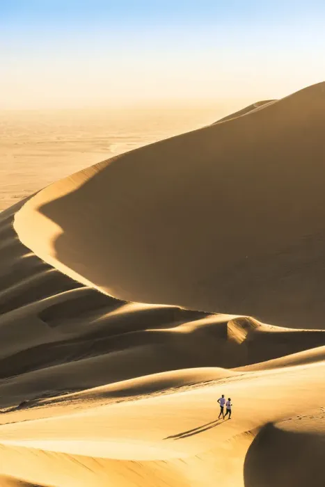 Framed Print : Walvis Bay, Namibia, Africa. Tourists walking on the sand dunes at sunset