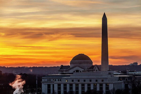 The Washington Monument and the dome of the Smithsonian Natural History Miuseum at sunset seen from Canadian Embassy on Penns. Ave