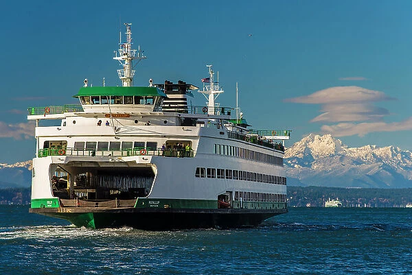 Washington State Ferry with snowy mountains of Olympic Peninsula in the background