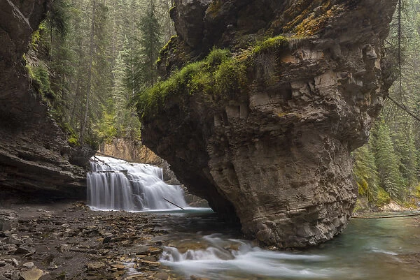 Waterfall at the base of a deep gorge at Johnston Canyon, Banff National Park, Canadian
