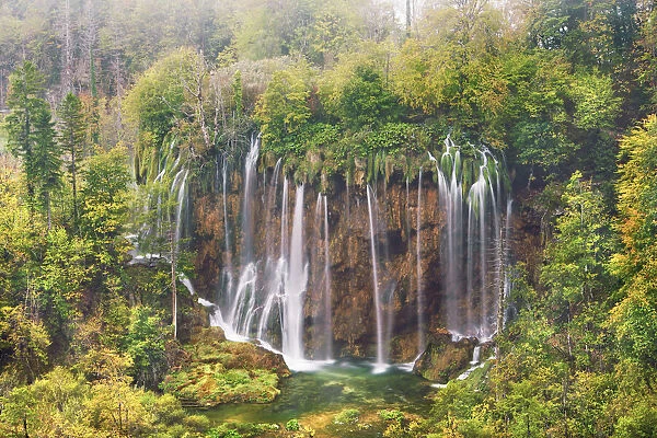 Waterfall in deciduous forest in autumn - Croatia, Lika-Senj