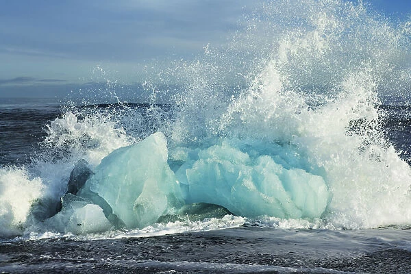 Wave breaking at iceblocks washed ashore - Iceland, Eastern Region