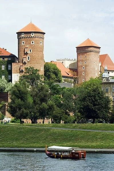 Wawel Hill Castle above Boat on the Vistula River