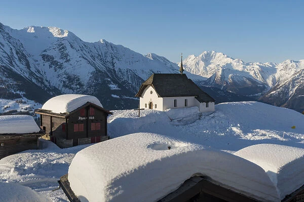 The white church of Bettmeralp in winter. Bettmeralep, Vallese, Switzerland, Europe