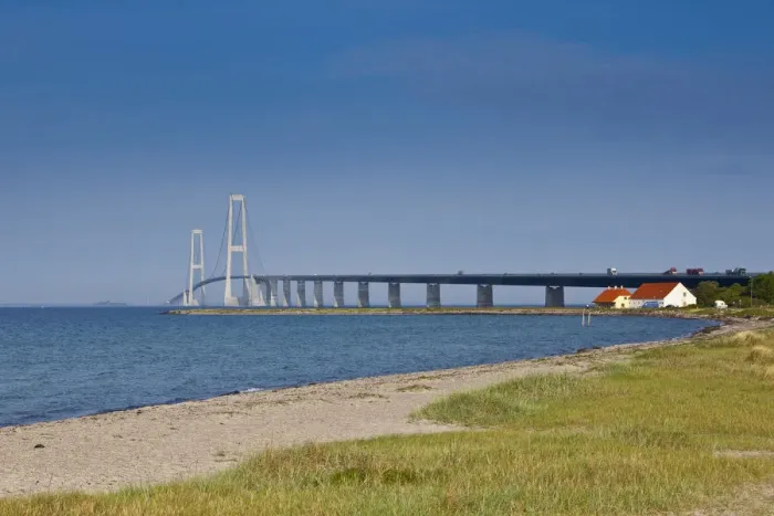 Framed Print : A white sand beach leads towards the East Bridge as seen from Korsor, Denmark Framed Print : A white sand beach leads towards the East Bridge as seen from Korsor, Denmark