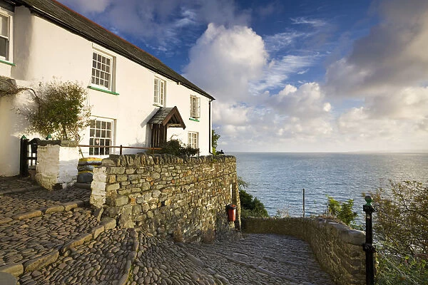 Whitewashed cottage and cobbled lane in the picturesque village of Clovelly, Devon