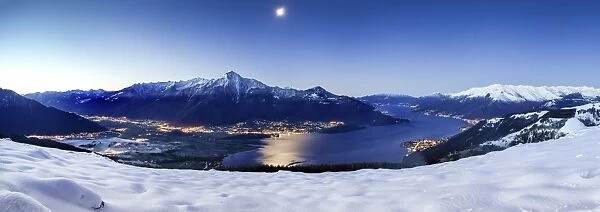 Wide angle shot of Alto Lario with Como lake and mount Legnone lighted by the moon in winter