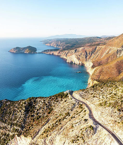 Winding coastal road overhanging the blue sea, Assos, Kefalonia, Ionian Islands, Greece