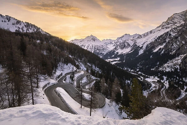 The winding curves of Maloja Pass road in winter at sunset, Bregaglia Valley, canton of Graubunden, Engadin, Switzerland