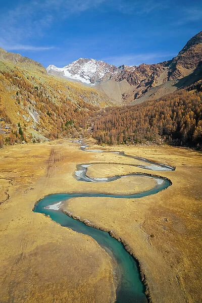 winding Duino river in Preda Rossa valley in front of Monte Disgrazia and Corni Bruciati. Val Masino, Sondrio province, Lombardy, Italy
