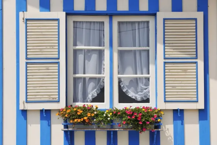 Framed Print : Window of a traditional striped painted house in the little seaside village of Costa Nova
