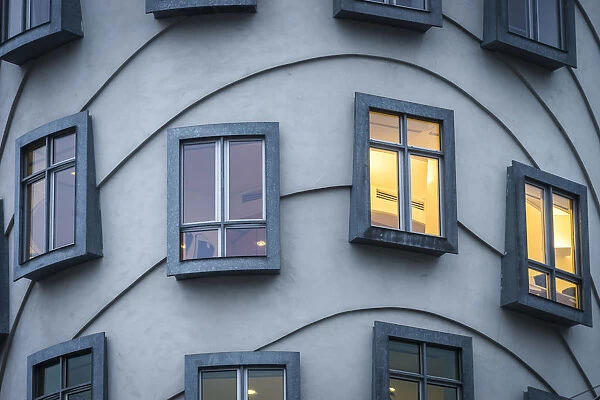 Detail of windows of Dancing House (AKA Fred and Ginger) at dusk, Prague, Bohemia