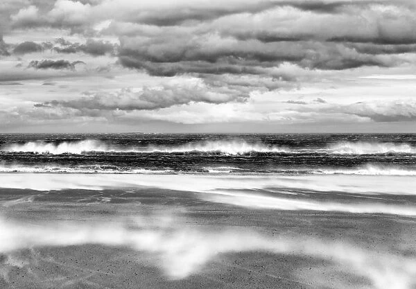 Windy day on a sandy beach between Bamburgh and Seahouses, Northumberland, UK