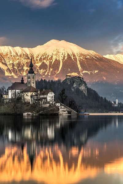 Winter sunset over Church of the Assumption of Mary, Lake Bled, Upper Carniola, Slovenia