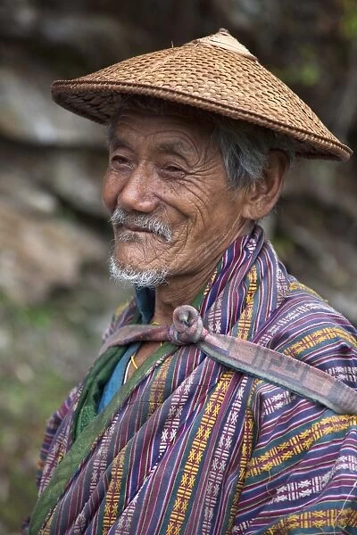 A wizened old farmer near Mongar wears the traditional knee-length national robe called gho