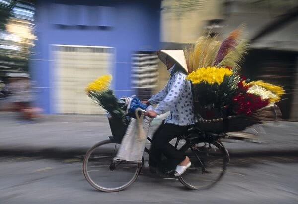 Woman on bike, Hanoi, Vietnam
