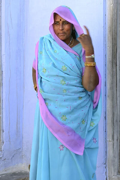Woman in brightly coloured sari in the Village of Pachewar, Rajasthan, India, Asia