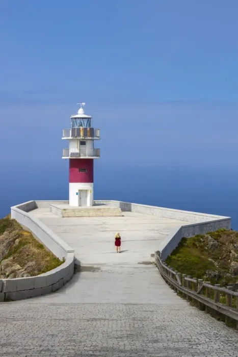 Framed Print : Woman at Cabo Ortegal and its lighthouse at sunrise, Galicia, Spain (MR) Framed Print : Woman at Cabo Ortegal and its lighthouse at sunrise, Galicia, Spain (MR)