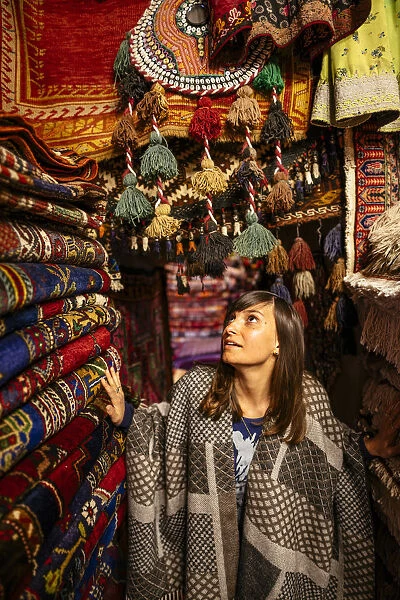 Woman in a carpet market shop in Goreme, Cappadocia, Central Anatolia, Turkey. (MR)