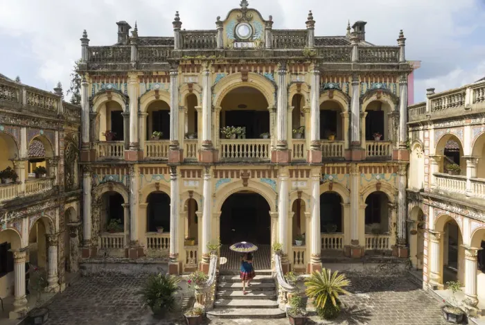 Framed Print : A woman carrying an umbrella walks into the Hoang A Tuong ancient palace in Bac Ha