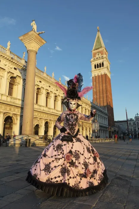 Framed Print : A woman in a colourful costume walks through St. Mark