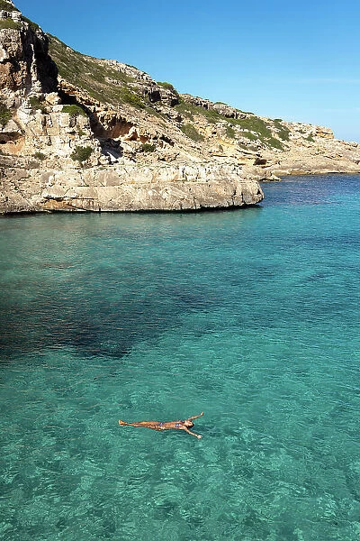Woman floating in the water, Mallorca, Spain