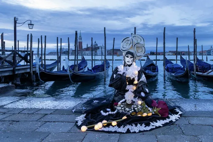 Framed Print : A woman in a flowery costume sits by the lagoon during the Venice Carnival, Venice, Italy Framed Print : A woman in a flowery costume sits by the lagoon during the Venice Carnival, Venice, Italy