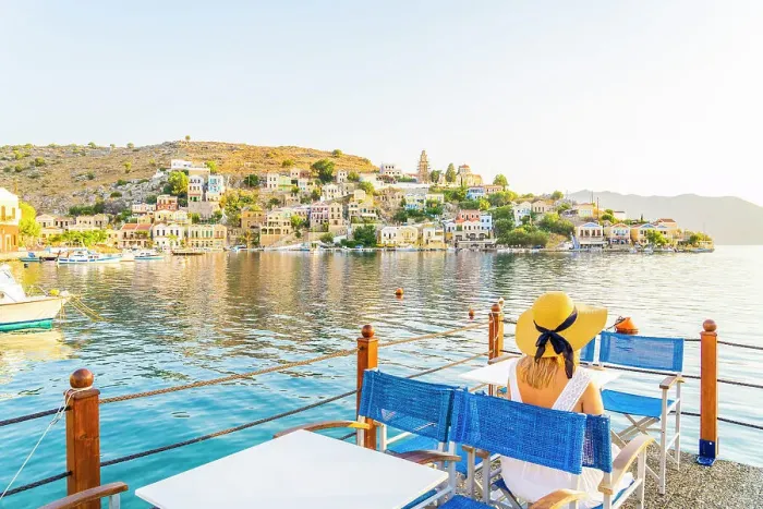 Framed Print : A woman in a hat by the colourful harbour in Symi, Dodecanese Islands, Greece. (MR) Framed Print : A woman in a hat by the colourful harbour in Symi, Dodecanese Islands, Greece. (MR)