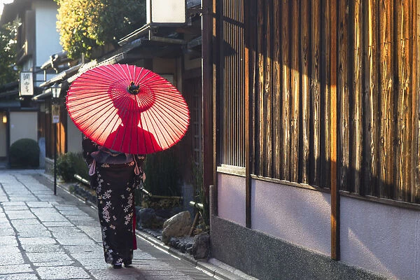 Woman in kimono walking along alleyway, Kyoto, Kansai, Japan (MR)
