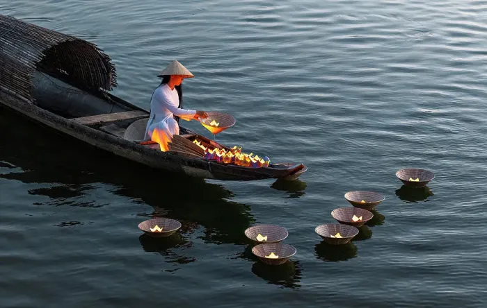 Framed Print : Woman laying floating lanterns on the Perfume River at dusk, Hue, Central Vietnam Framed Print : Woman laying floating lanterns on the Perfume River at dusk, Hue, Central Vietnam