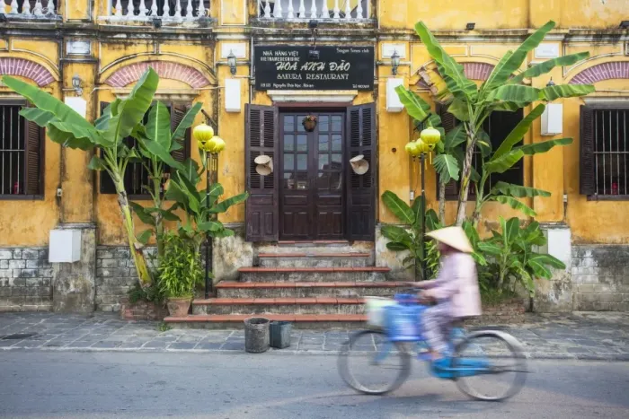 Framed Print : Woman riding bicycle past restaurant, Hoi An (UNESCO World Heritage Site), Quang Ham