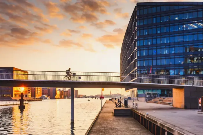 Framed Print : A woman riding a bike on the bike bridge over the water canal Framed Print : A woman riding a bike on the bike bridge over the water canal