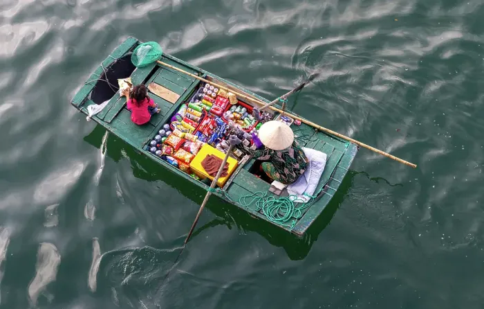 Framed Print : Woman selling snacks from her boat to tourists, Halong Bay, North Vietnam