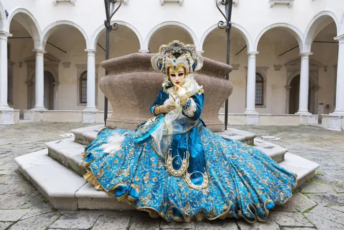 Framed Print : A woman sits in a magnificent costume in front of a well during the Venice Carnival Framed Print : A woman sits in a magnificent costume in front of a well during the Venice Carnival