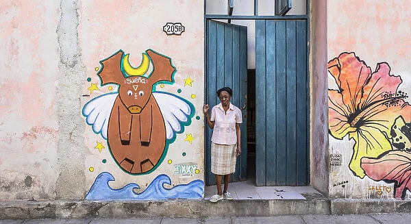 A woman standing in the doorway of her house in La Habana Vieja (Old Town), Havana, Cuba