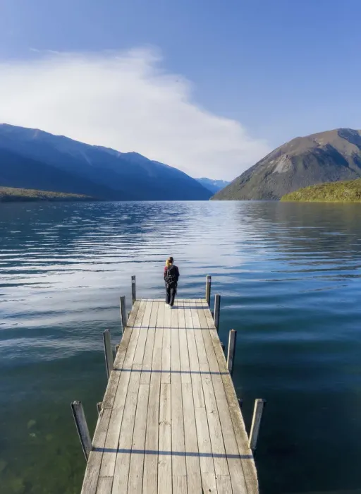Framed Print : A woman standing on the wooden jetty and enjoying the view of the Rotoiti lake Framed Print : A woman standing on the wooden jetty and enjoying the view of the Rotoiti lake